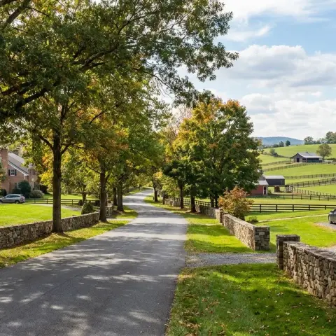 Charming residential street in Aldie, Virginia with stone fences and rolling green hills of Loudoun County