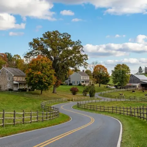 Rolling countryside and farmhouse-style homes in Boyds Maryland with mature hardwood trees