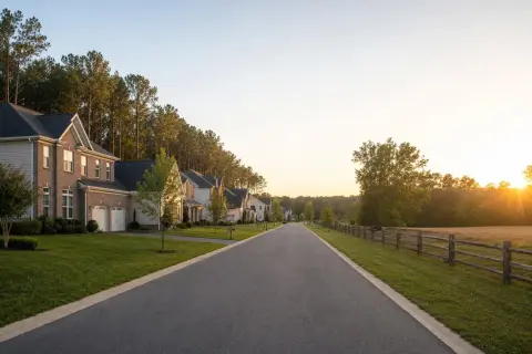 Residential street in Brandywine, Maryland with newer colonial homes backing onto a pine and hardwood tree line