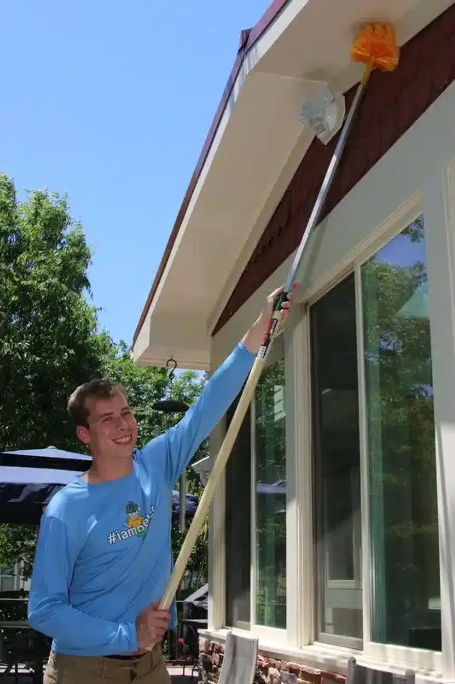 Technician treating home exterior foundation area