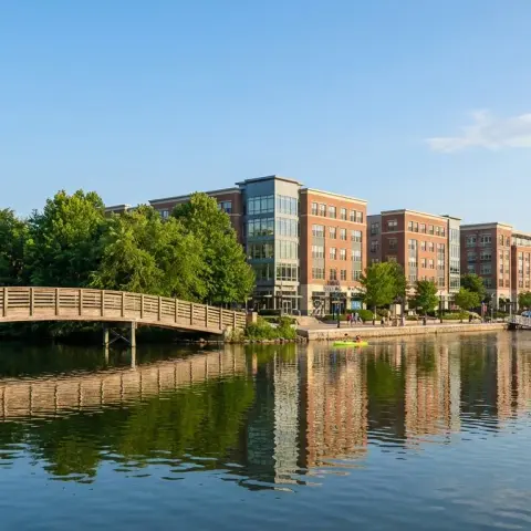 Scenic lakefront view of Columbia Maryland community with trees and calm water reflections