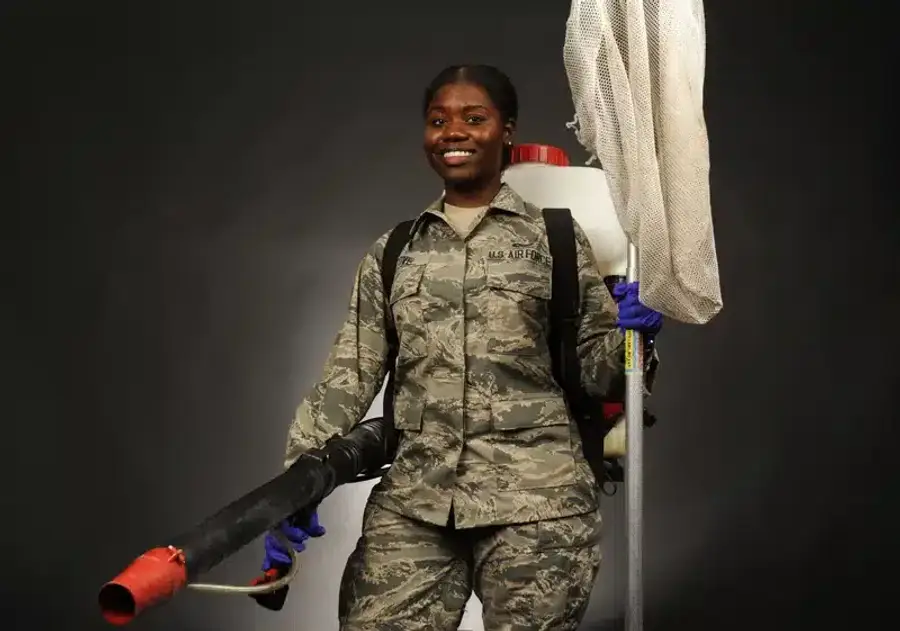 Pest control technician inspecting a home's foundation