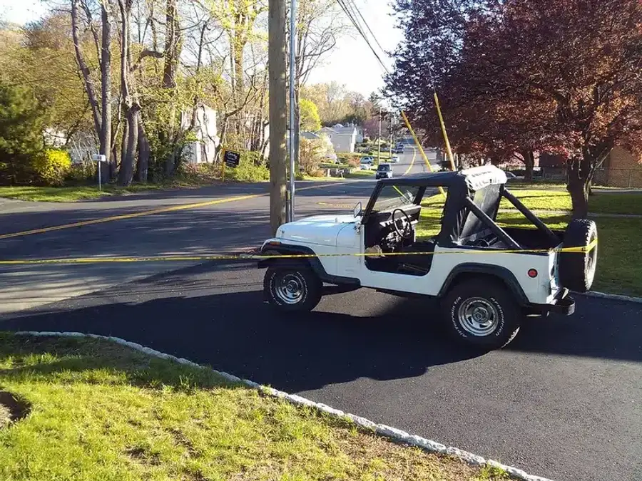 White Jeep parked on the roadside