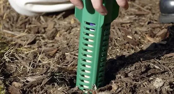 Sentricon termite bait station being placed in the ground at a Great Falls property for year-round termite protection