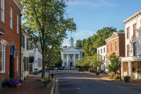Historic Main Street in Old Town Warrenton Virginia with brick storefronts, shade trees, and the white-columned courthouse